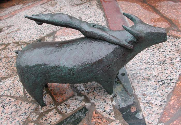 Balancing - a bronze sculpture of a man balancing on a bull by Shen Xiaonan