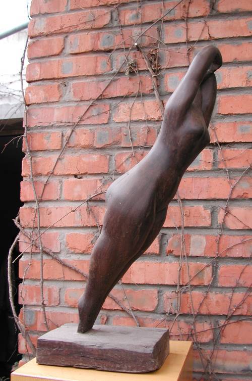 Morning - a sculpture of a woman stretching by Shen Xiaonan - side view